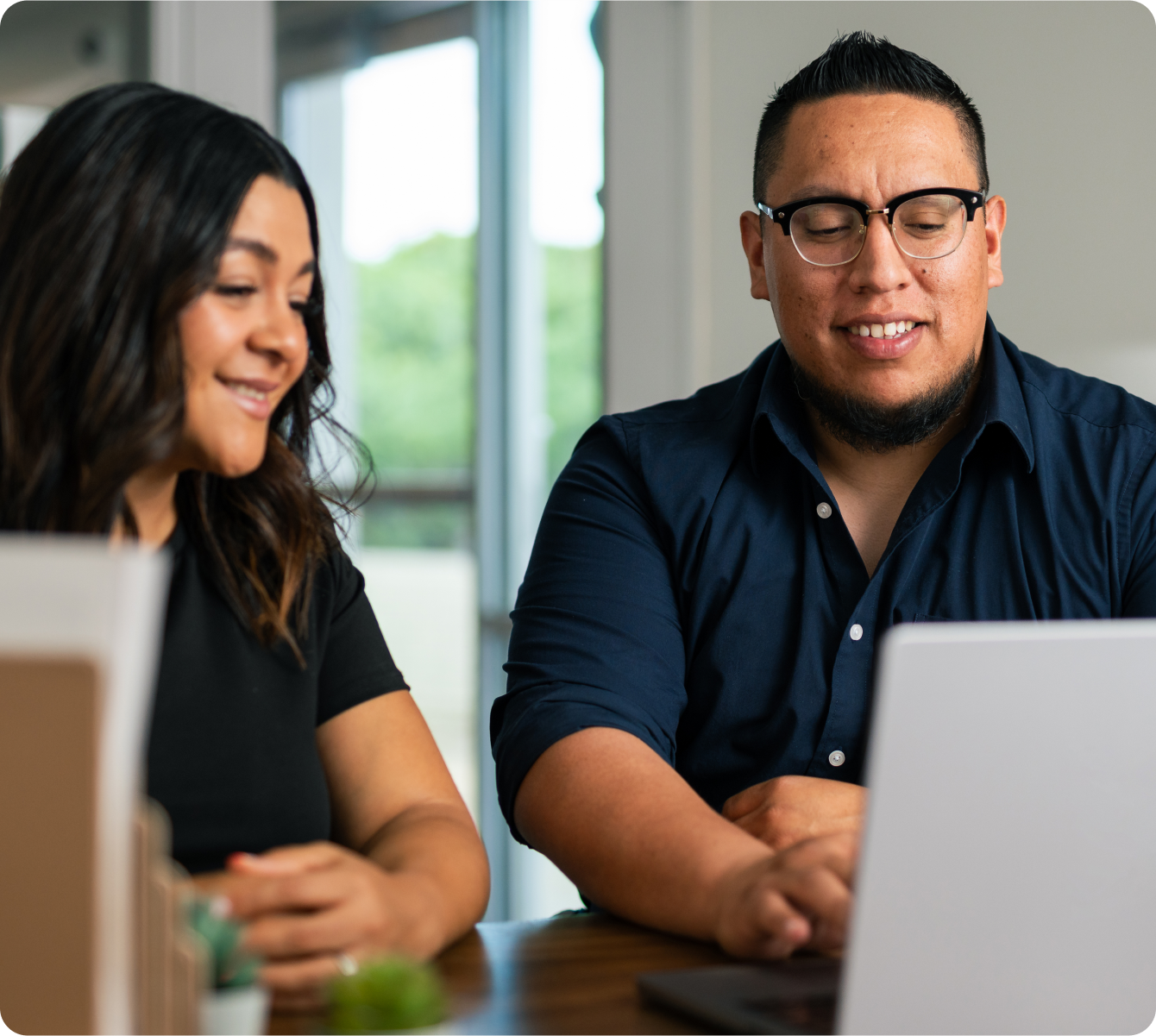 Two people looking at laptop