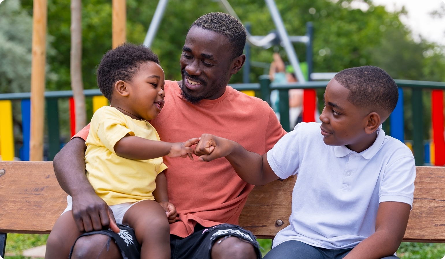 Dad on a bench with two sons