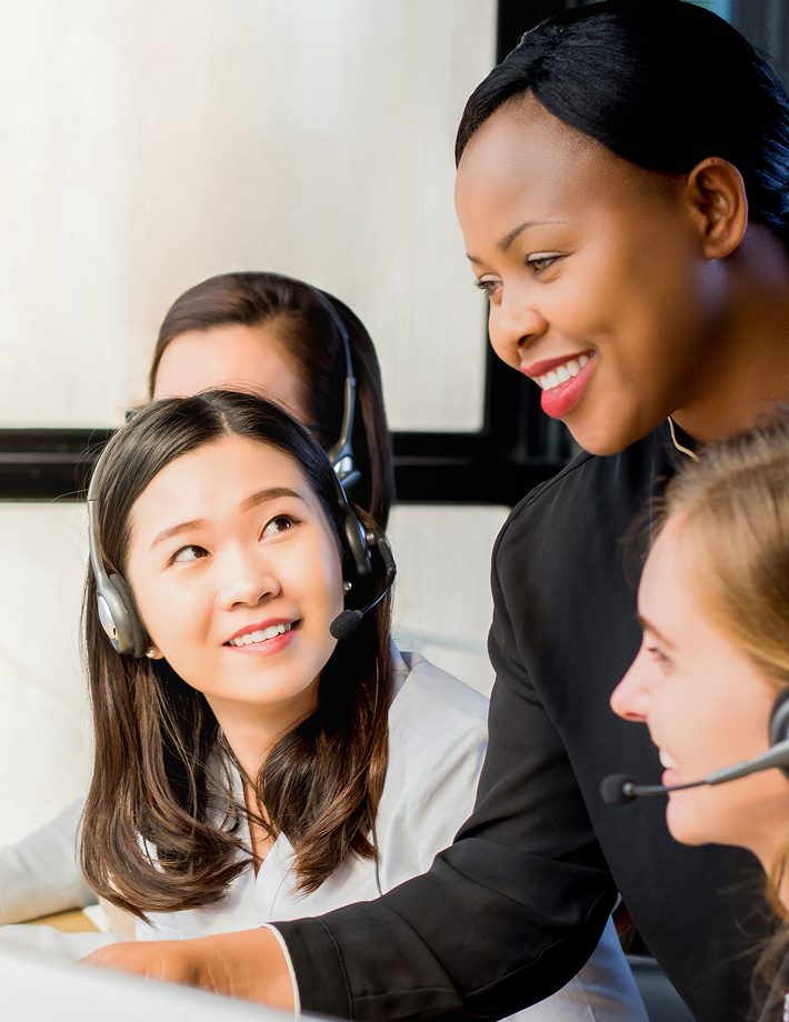 A woman explains something to two female colleagues